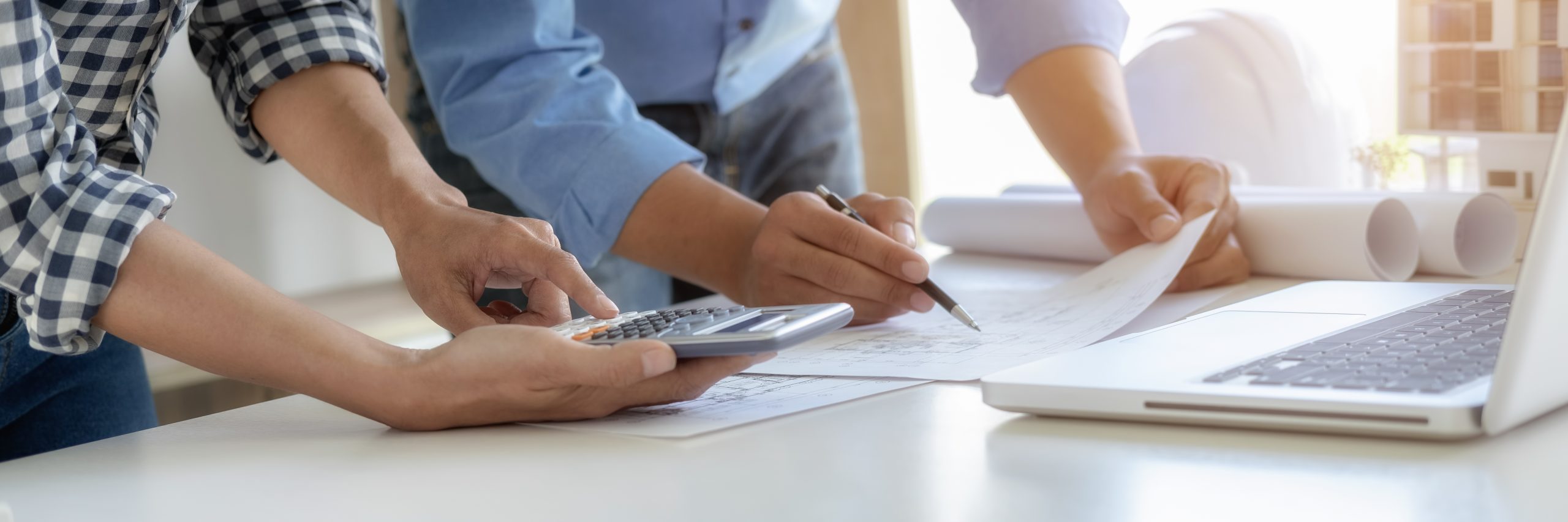 Två personer läser från ett papper och använder en miniräknare