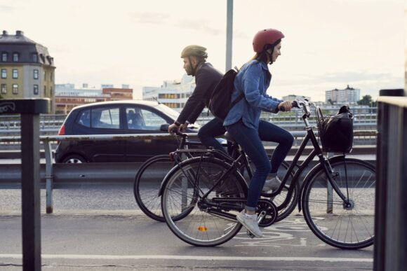 Två personer cyklar i motsatt riktning över skanstullbron i stockholm